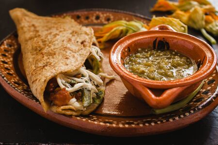 mexican quesadilla with squash blossom, cheese and spicy sauce in mexico city