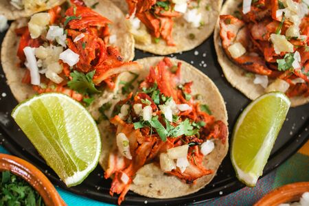 Fresh Mexican tacos al pastor with lemon and sauce in Mexico