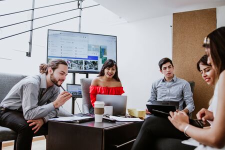 Group of young Latin people teamwork or mexican coworkers working in an office in Mexico Americaの写真素材