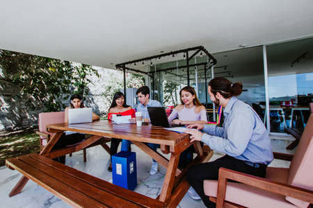 Hispanic University students together with computer or laptop in Mexico Latin America