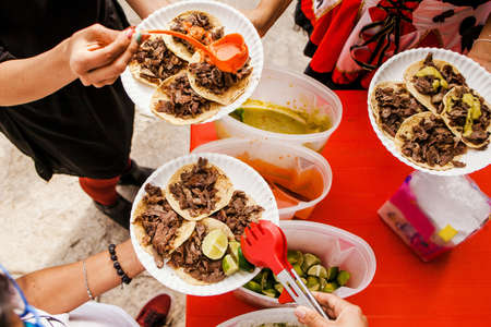Mexican People eating tacos al pastor in Taqueria in Mexicoの写真素材