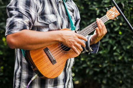 latin musician playing a guitar at the street in Mexico cityの写真素材