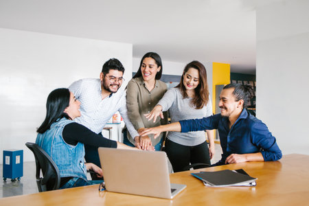 Group of latin business people working together as a teamwork while sitting at the office desk in a creative office in Mexico cityの写真素材