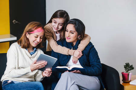 Latin Woman mother have fun with daughters. Mother's Day love family, parenthood childhood conceptの写真素材