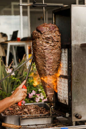 cooking Mexican tacos with beef, traditional street food in Mexico cityの写真素材