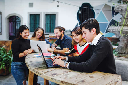 Group of young latin college students developing a project at the university in Mexicoの写真素材