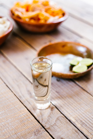 mexican tequila shot with lime and salt in a rustic table in Mexico cityの写真素材