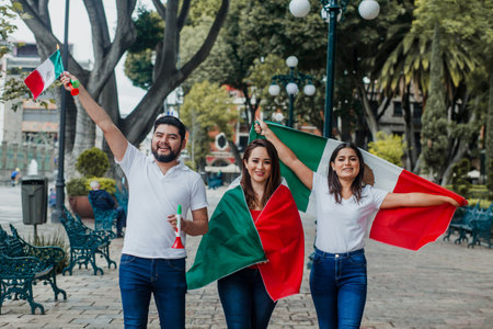 Group of Mexican friends celebrating Mexican Independence Day with flags in Mexico Cityの写真素材