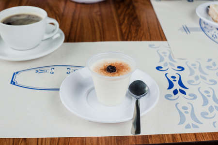 Glass of rice pudding with raisin and sprinkled cinnamon, mexican desserts in restaurant in Mexico Cityの写真素材
