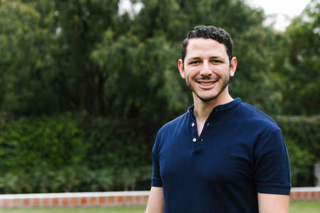 portrait of young Hispanic man at the park in latin americaの写真素材