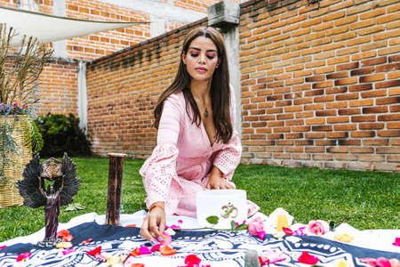 Hispanic holistic therapist girl using different elements for holistic session outdoors in Latin Americaの写真素材