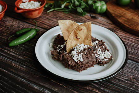 Mexican refried beans with cheese and nachos tortilla corn traditional in Mexican gastronomy in Mexicoの写真素材