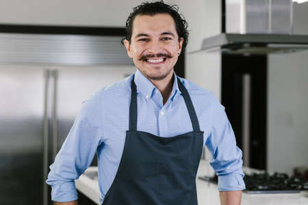 young latin man chef portrait at kitchen in Mexico Latin America