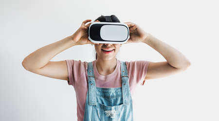 young latin woman with glasses of virtual reality on a white background. Future technology concept....