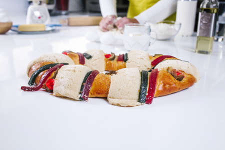 mexican woman baking a traditional rosca de reyes or epiphany cake on the oven in kitchen at home for Kings Day in Mexico Latin Americaの写真素材