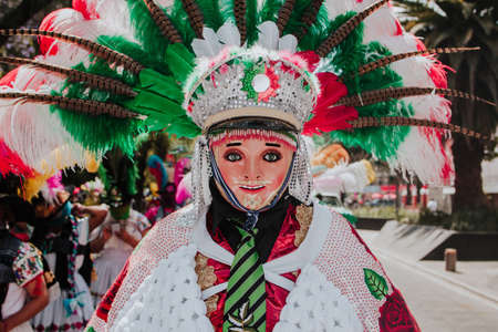 Huehues Mexico, Mexican Carnival dancer wearing a traditional folk costume and mask in Latin Americaの素材 [FY310179309117]