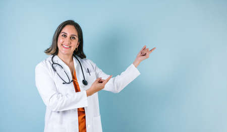 latin doctor woman over blue background laughing in Mexico Latin Americaの写真素材