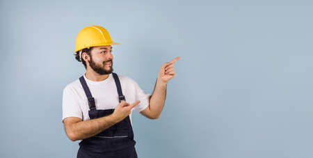 Hispanic man Professional engineering and worker with helmet pointing to copy space in Mexico Latin Americaの写真素材