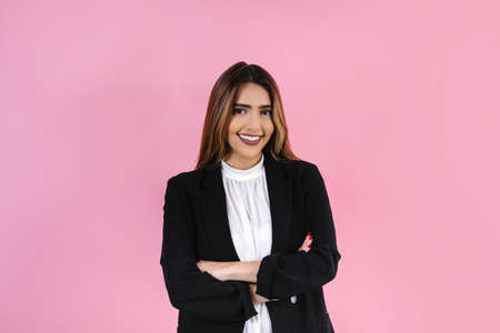 young hispanic business woman portrait smiling at camera on pink background in Mexico Latin America