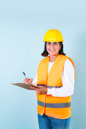 Hispanic woman Professional engineer and worker, builder or contractor with helmet in Mexico Latin...