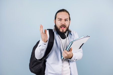 young latin man student university on blue background in Mexico Latin Americaの写真素材
