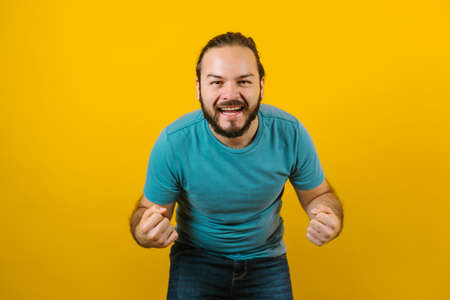 Young hispanic man portrait on yellow background in Mexico Latin Americaの写真素材
