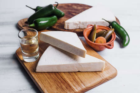 Mexican white Cotija cheese, tequila shot with fresh ingredients in Mexico Latin America