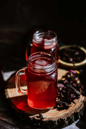 Hibiscus tea in a glass jar on a dark backgroundの写真素材