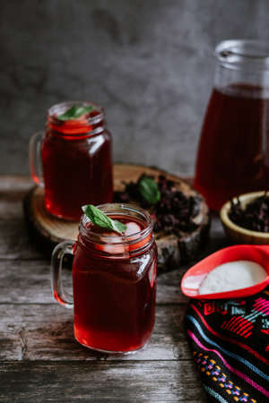 Hibiscus tea in a glass jar on a wooden backgroundの写真素材