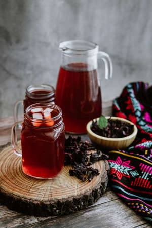 Hibiscus tea in a glass jar on a wooden backgroundの写真素材