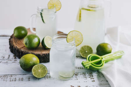 Refreshing lemonade with lime on a white wooden background.の写真素材