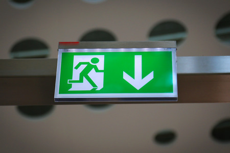Emergency exit sign above a black doorwayの写真素材