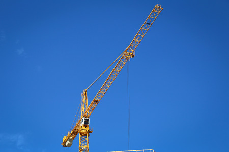 Yellow construction crane on a nice day.