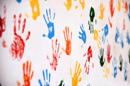Old wall with multicolored prints of palmsの写真素材