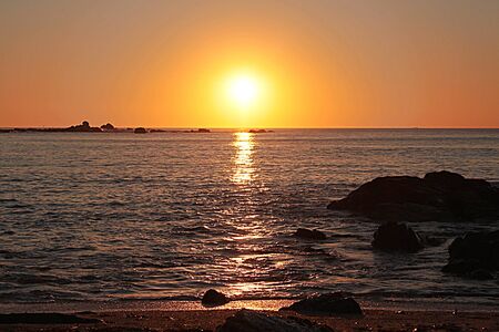 sunset on the beach of Algarrobo, Chile. Overlloking the horizon, the sun and the sea at eveningの写真素材