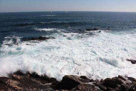 beautiful view of sea waves bursting in the rocks creating foam in Algarrobo beach in Chileの写真素材