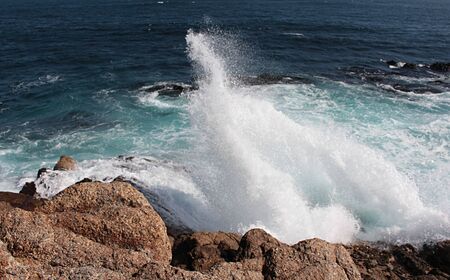 beautiful view of sea waves bursting in the rocks creating foam in Algarrobo beach in Chile