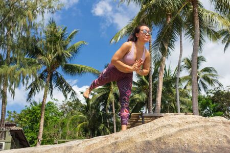 Asian Thai woman practicing yoga in Haad Chao Phao beach, Koh Phangan islandの写真素材
