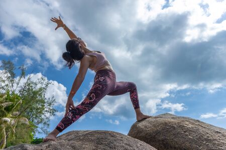 Asian Thai woman practicing yoga in Haad Chao Phao beach, Koh Phangan islandの写真素材
