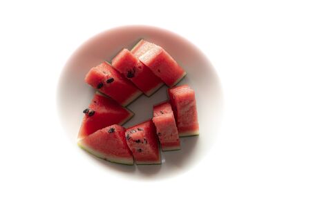 Tropical fruit. Delicious fresh watermelon cut in pieces, ready to be eaten, served on a plate.