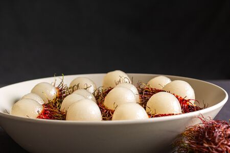 Rambutan, a delicious Thai fruit served on a plate