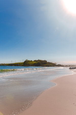 Beautiful beach in the morning light with blue sky and white cloudsの写真素材