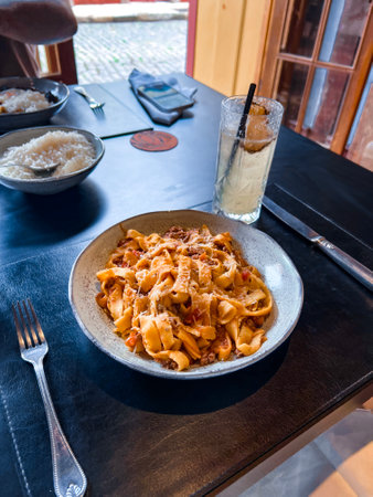 Tagliatelle pasta with tomato sauce and parmesan cheeseの写真素材