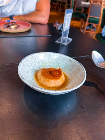 Caramel custard pudding on the table in a restaurant.