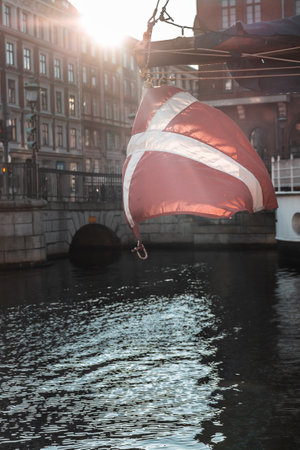 denmark flag hanging from a boat on a sunny dayの写真素材