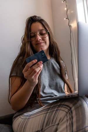 young woman shopping online with credit card