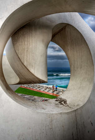 View of the ocean through the window of a modern building
