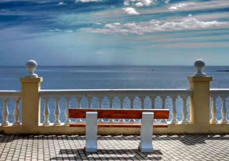 A bench on the embankment of the Black Sea in Sochi, Russiaの写真素材