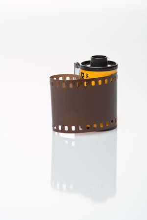 Vintage 35 mm negative film strip on white background with reflection.の写真素材