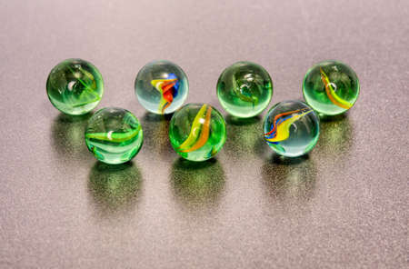 Colorful marbles on a gray background. Selective focus.